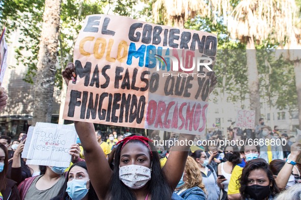 Protester is seen with a sign that says, the Colombian government is more false than my pretense of orgasm
About 400 people, mostly from the...
