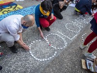 Protesters are seen lighting candles that form the word colombia
About 400 people, mostly from the Colombian community of Barcelona, have de...