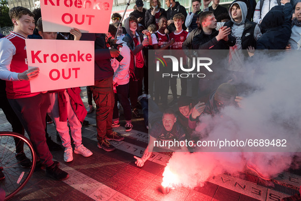 LONDON, UNITED KINGDOM - MAY 06, 2021: Arsenal fans set off a flare as they gather outside the Emirates Stadium ahead of the Europa League s...