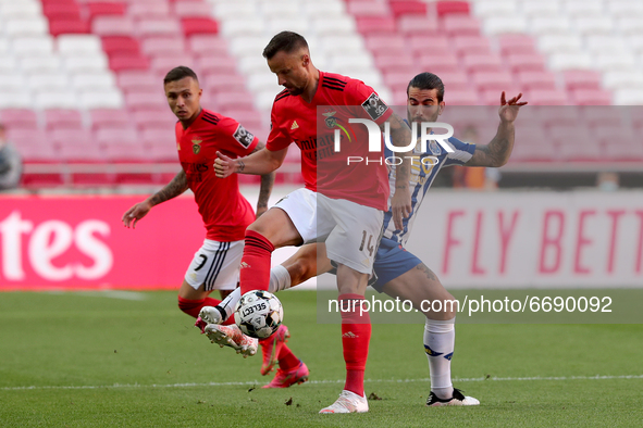 Haris Seferovic of SL Benfica (C ) vies with Sergio Oliveira of FC Porto (R ) during the Portuguese League football match between SL Benfica...