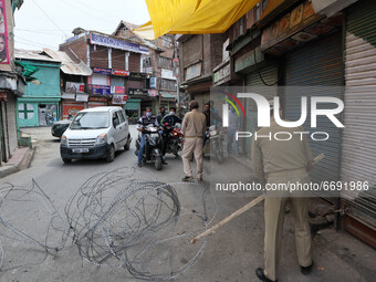 Indian police forces stop civilian traffic outside Kashmir's grand mosque during Covid-19 lockdown on the last friday of Ramadan in Srinagar...