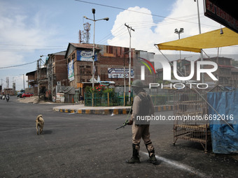 An Indian trooper stands outside Kashmir's grand mosque during Covid-19 lockdown on the last friday of Ramadan in Srinagar, Indian Administe...