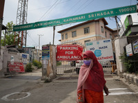 A woman walks outside a hospital during Covid-19 lockdown on the last friday of Ramadan in Srinagar, Indian Administered Kashmir on 07 May 2...