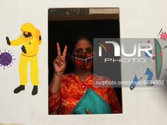 A woman poses for a picture after getting a dose of COVAXIN, a coronavirus (COVID-19) vaccine manufactured by Bharat Biotech, at a vaccinati...