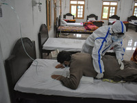 A Health worker helps a Covid-19 patient with breathing exercise at a temporary Covid-19 hospital in Srinagar, Indian Administered Kashmir o...