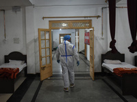 A Health worker inspects beds at a temporary Covid-19 hospital in Srinagar, Indian Administered Kashmir on 08 May 2021. A Local NGO Athrout...