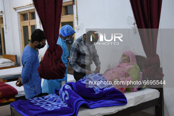 A Health worker examins a Covid-19 patient at a temporary Covid-19 hospital in Srinagar, Indian Administered Kashmir on 08 May 2021. A Local...