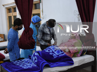 A Health worker examins a Covid-19 patient at a temporary Covid-19 hospital in Srinagar, Indian Administered Kashmir on 08 May 2021. A Local...
