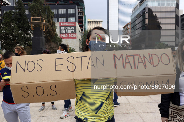 A man holds a placard while joins a demonstration at Monument of Revolution to protest against the repression and killings in Colombia of pr...