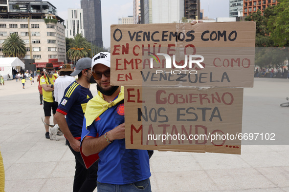 A person holds a placard while joins a demonstration at Monument of Revolution to protest against the repression and killings in Colombia of...