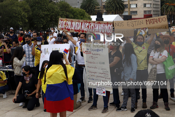 Persons  hold  placards while join a demonstration at Monument of Revolution to protest against the repression and killings in Colombia of p...