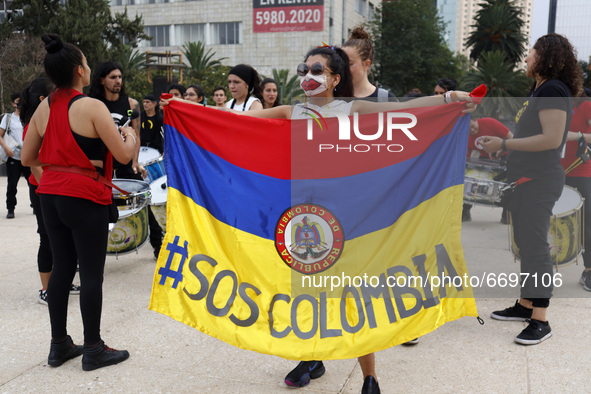 A woman holds a Colombian flag while joins a demonstration at Monument of Revolution to protest against the repression and killings in Colom...