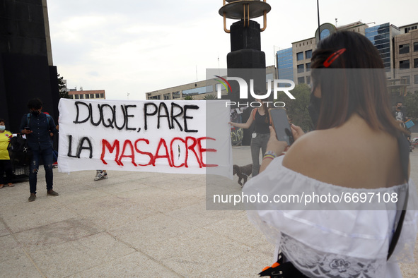 A woman takes a photo to demonstrators  holding a placard during a demonstration at Monument of Revolution to protest against the repression...