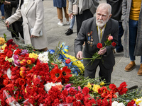 Elderly man  carries flowers at the Tomb of the Unknown Soldier as he marks the Victory Day, the 76th anniversary of the victory over Nazi G...
