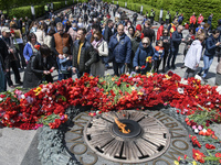 People carries flowers at the Tomb of the Unknown Soldier as they marks the Victory Day, the 76th anniversary of the victory over Nazi Germa...