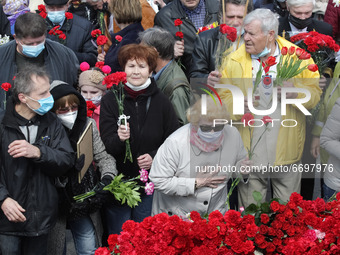 People lay flowers to the Monument of Eternal Glory on the Tomb of the Unknown Soldier, during the Victory Day celebration amid the Covid-19...