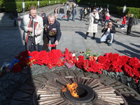 People  lay flowers to the Monument of Eternal Glory on the Tomb of the Unknown Soldier, during the Victory Day celebration amid the Covid-1...