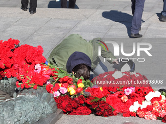 A man bows in front of the Monument of Eternal Glory on the Tomb of the Unknown Soldier, during the Victory Day celebration amid the Covid-1...