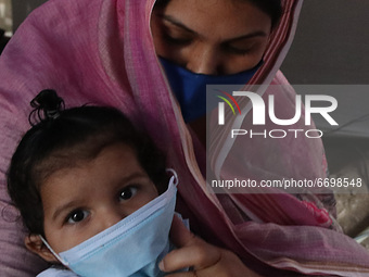 A Mother adjust Surgical face mask on her child at a  Health Camp amid Covid-19 pandemic on Mothers Day in Kolkata on May 09,2021. (