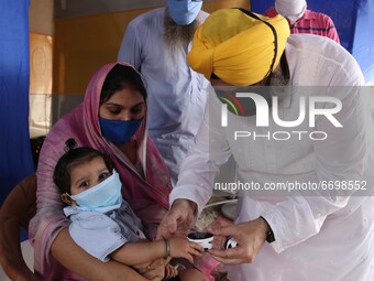 A Mother with  her child  check oxygen saturation   a  Health Camp amid Covid-19 pandemic on Mothers Day in Kolkata on May 09,2021. (