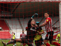  Jonathan Mitchell of Northampton Town punches the ball over the bar under pressure from Sunderland's  Charlie Wyke  during the Sky Bet Leag...