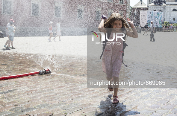 In Warsaw on castle square set a water curtain, so that everyone can cool off on hot days, on July 3, 2015, in Warsaw, Poland. 