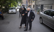 An Iranian woman helps her elderly father while arriving a health center for receiving a d...