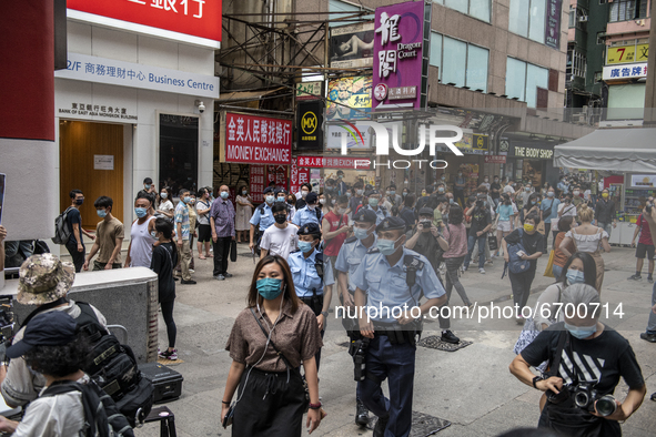 Police Officers walks towards a booth for the June 4 Vigil in Hong Kong, Sunday, May 9, 2021. The Hong Kong Alliance in Support of Patriotic...