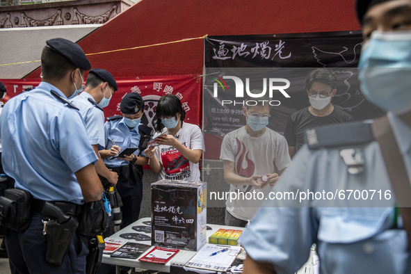 Police Officers surrounded a booth for the June 4 Vigil in Hong Kong, Sunday, May 9, 2021. The Hong Kong Alliance in Support of Patriotic De...