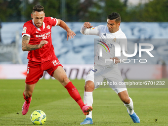 Lucas Ocampos of Sevilla CF in action with Casemiro of Real Madrid during the Spanish Liga Santander match between Real Madrid and Sevilla F...