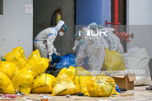 Health worker disposing waste material used by COVID-19 patients at a hospital in Kolkata , India , on 10 may 2021 .  India saw a decline of...