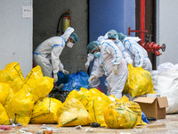 Health worker disposing waste material used by COVID-19 patients at a hospital in Kolkata , India , on 10 may 2021 .  India saw a decline of...
