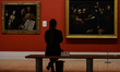 A visitor looks at 'The Taking of Christ' by Michelangelo Merisi de Caravaggio inside the...
