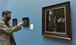 Irish TV presenter Ryan Tubridy takes a photo of an oil painting 'Woman Writing a Letter,...