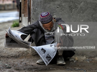 A Man reading a newspaper outside a hospital in Sopore, District Baramulla, Jammu and Kashmir, India on 11 May 2021. Huge rush was seen in t...