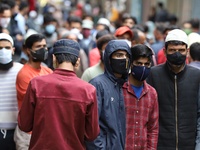 People with masks walk through a crowded area without maintaining Social distancing ahead of Muslim Festival Eid-Ul-Fitr in Sopore, District...