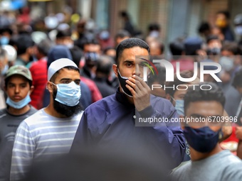 A Boy wearing a mask improperly along with others is seen at a crowded area ahead of Muslim Festival Eid-Ul-Fitr in Sopore, District Baramul...