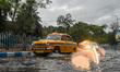 various vehicles tries to make their way through a flooded road after heavy monsoon rain i...