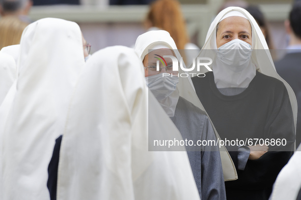 A group of nuns waits Pope Francis in the St. Damaso Courtyard at the Vatican for his weekly general audience, Wednesday, May 12, 2021.  