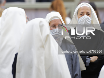A group of nuns waits Pope Francis in the St. Damaso Courtyard at the Vatican for his weekly general audience, Wednesday, May 12, 2021.  (