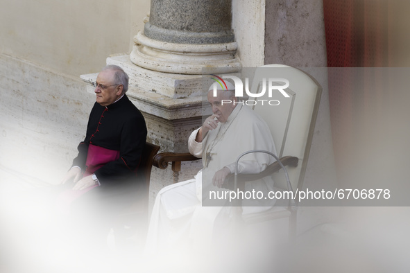Pope Francis, right, begins the general audience in the St. Damaso Courtyard at the Vatican, Wednesday, May 12, 2021.  