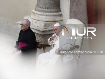 Pope Francis, right, begins the general audience in the St. Damaso Courtyard at the Vatican, Wednesday, May 12, 2021.  (