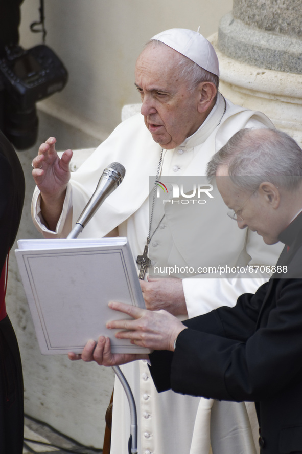 Pope Francis, right, blesses in the St. Damaso Courtyard at the Vatican at the end of his weekly general audience, Wednesday, May 12, 2021....