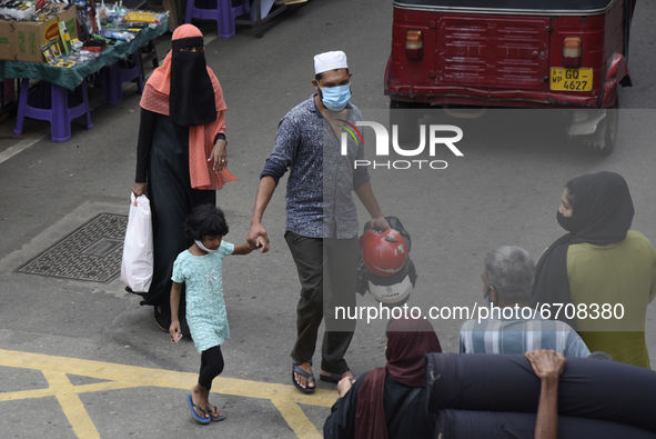 A Muslim woman wearing a niqab walk in along near Colombo, Sri Lanka May 12, 2021 