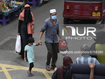 A Muslim woman wearing a niqab walk in along near Colombo, Sri Lanka May 12, 2021 (