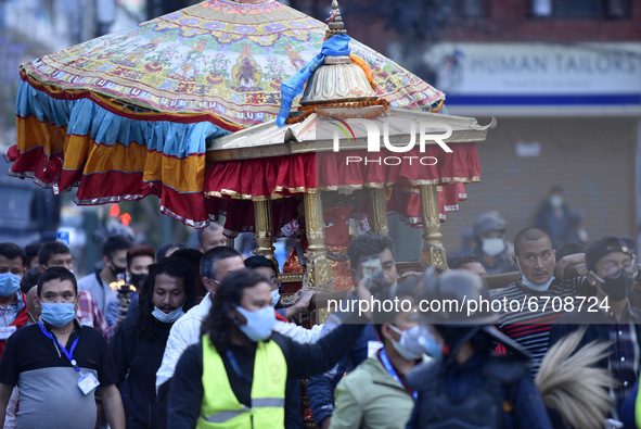 Nepalese Priest carrying idol Rato Machindranath from Machindra Bahal towards the chariot on the first day of the longest chariot festival o...