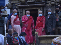 Nepalese Priest arrange to carry idol Rato Machindranath towards the chariot on the first day of the longest chariot festival of Nepal durin...
