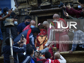 Nepalese Priest carrying idol Rato Machindranath towards the chariot on the first day of the longest chariot festival of Nepal during prohib...