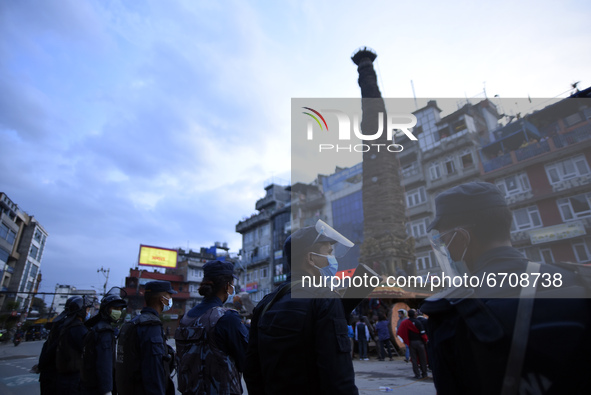 Nepalese Police guard around the chariot during procession of Rato Machindranath towards the chariot on the first day of the longest chariot...