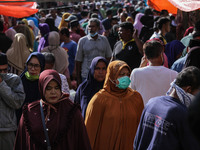 People are seen gathering a traditional market to buy meat, as a tradition before celebrating Eid al-Fitr called" Meugang" in Lhokseumawe, o...